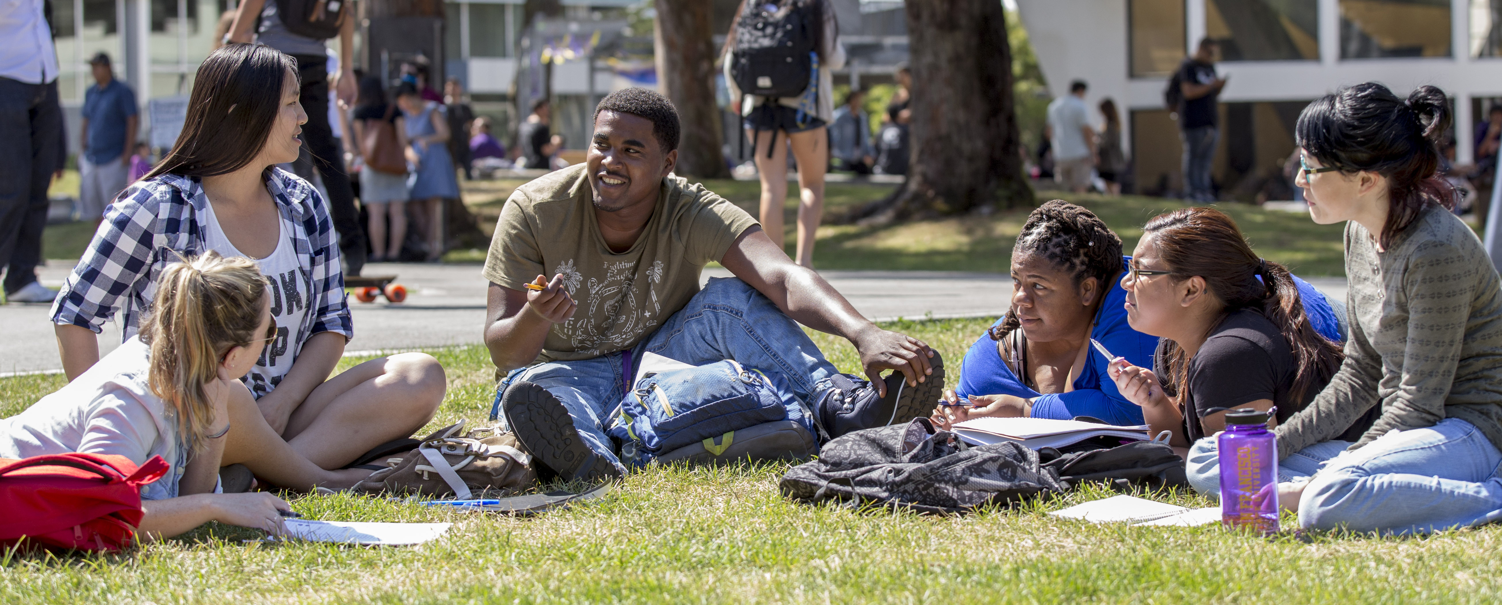 Students spending time together on campus lawn